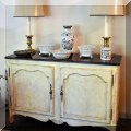 F09. French provincial two door cabinet. 34.5”h x 53”w x 20”d 